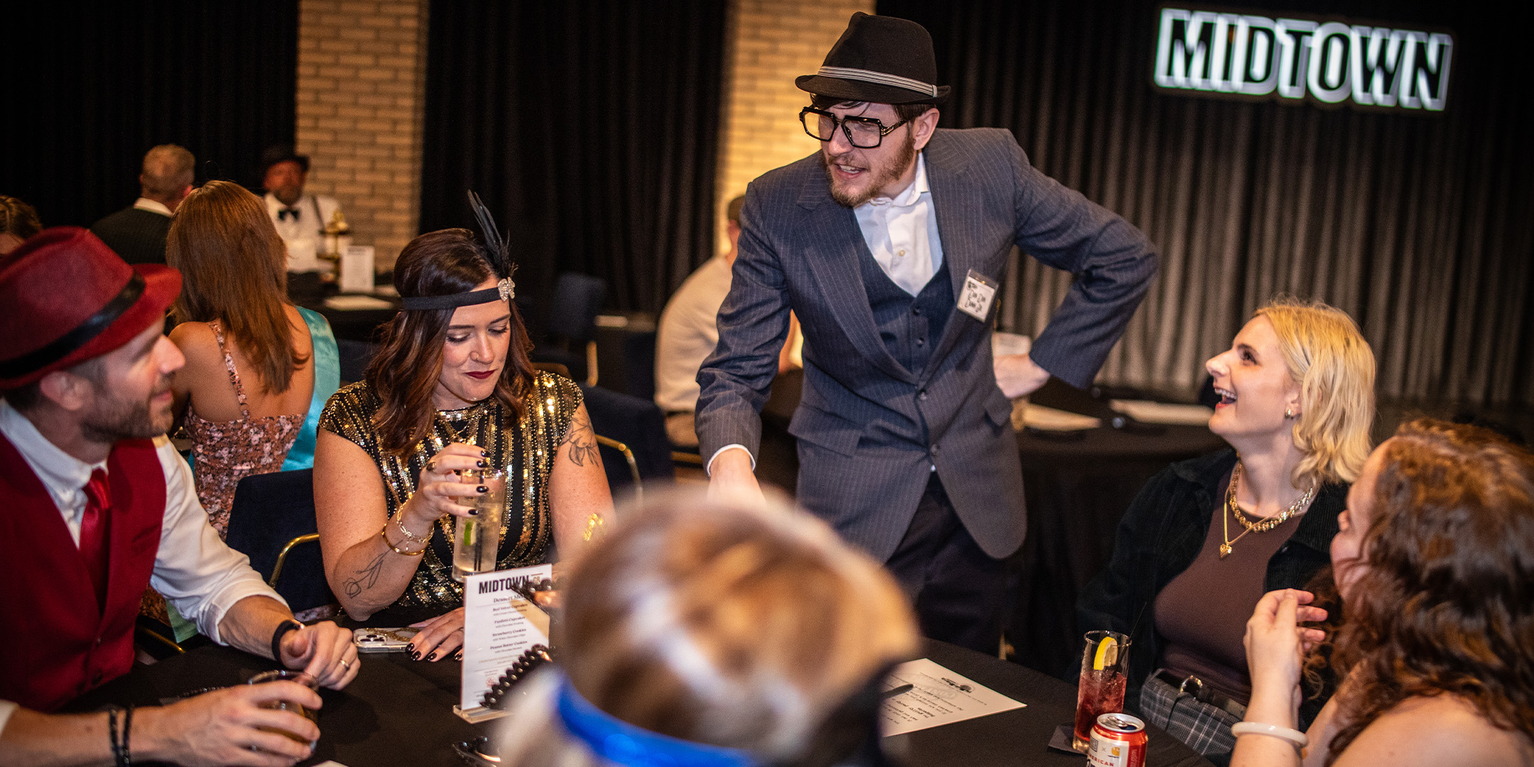 Guests at a Murder Mystery Company public dinner show in New York